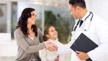 Food allergy doctor greets child and mother